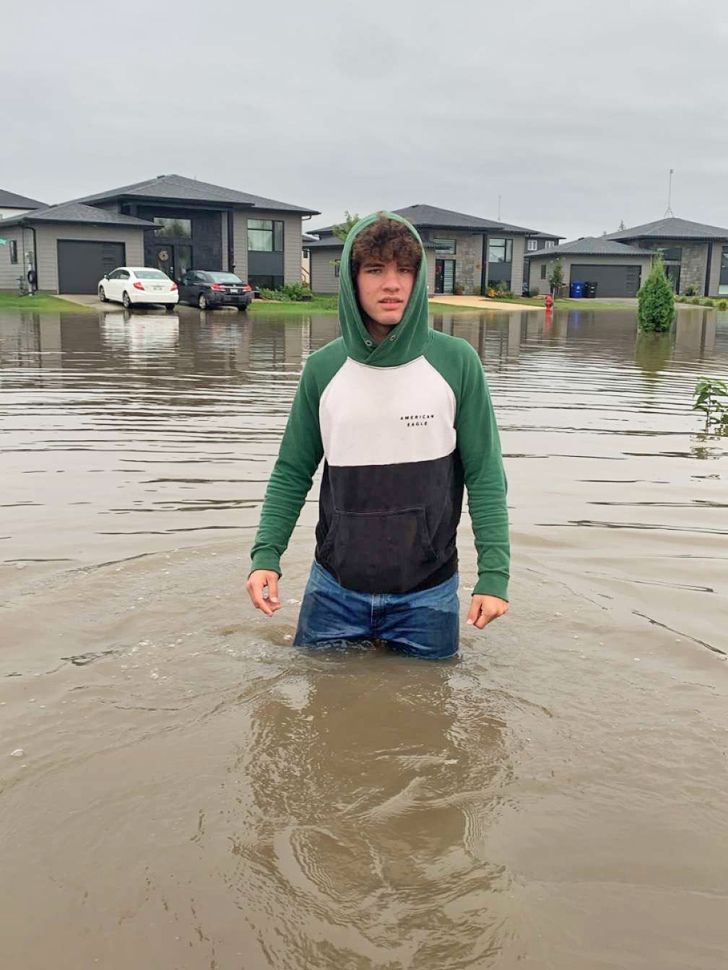 Waist-deep on a flooded street in Kleefeld on Tuesday morning