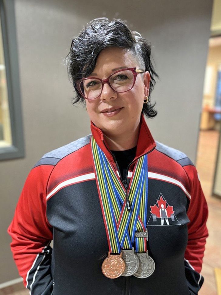 Jacqui Broesky wearing her three medals.