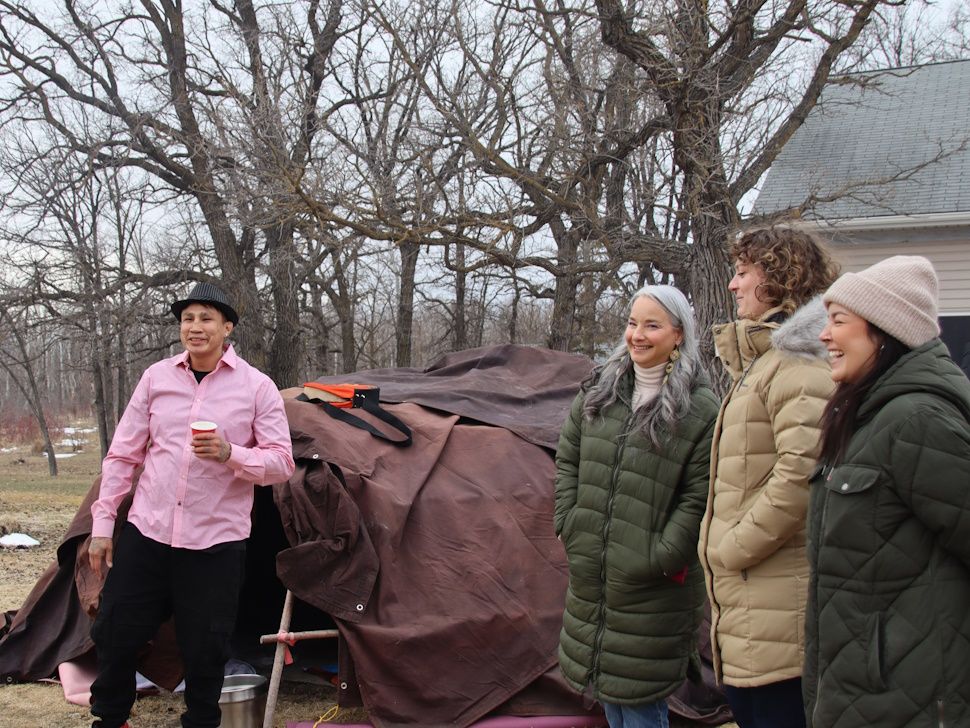Minister stands in front of sweat lodge