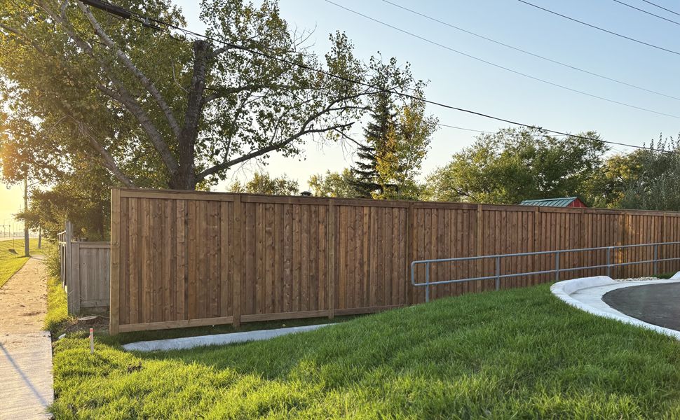 Wooden fence borders the McDonalds restaurant in Niverville on the west and north sides.