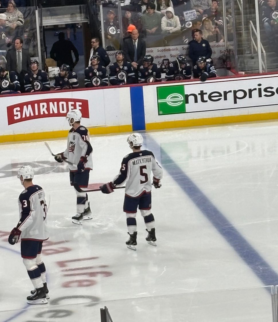 Mateychuk stands in front of the Jets bench