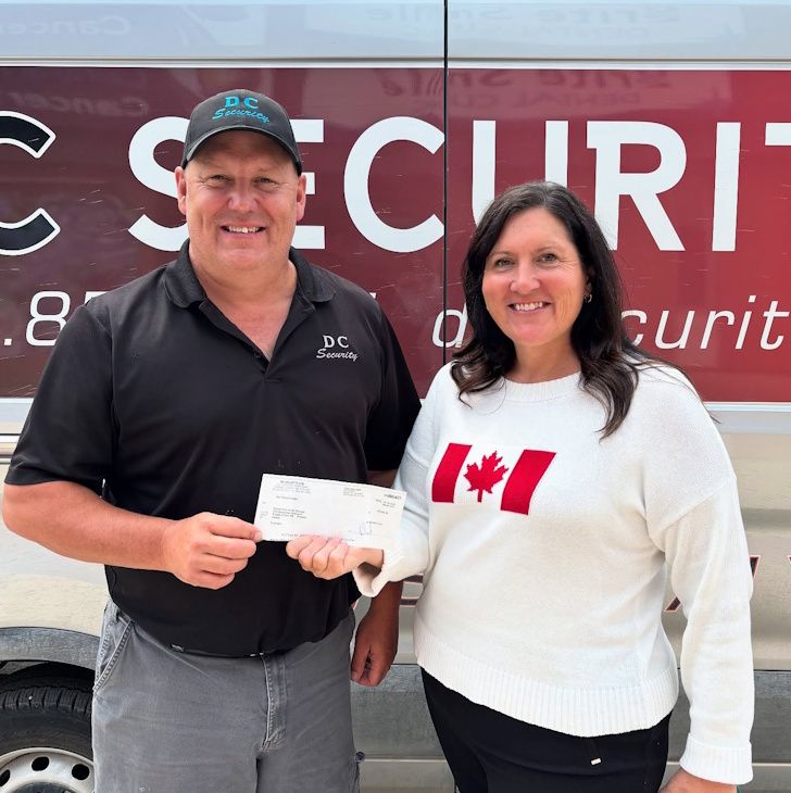 Dean Cairns, owner of DC Security, presenting Mayor Sharilyn Knox, Executive Director of Central Plains Cancer Services with a cheque for $2,000 that he raised at his 30th anniversary celebration yesterday