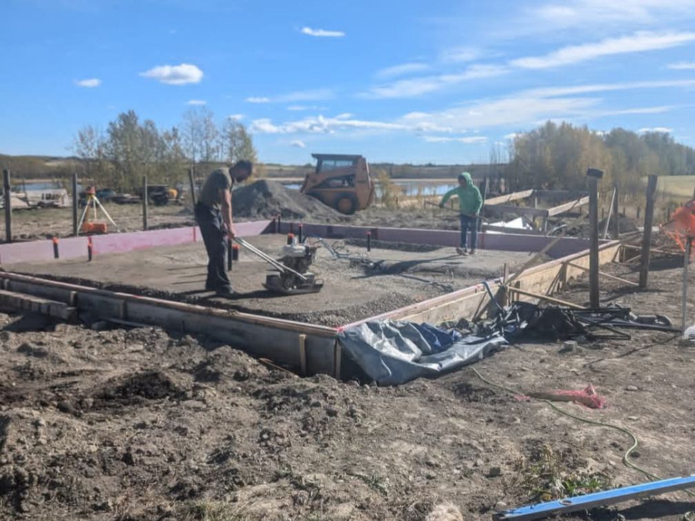 Danielle and John Losier working on the foundation of the home they had been building on raw land north of Cochrane. The family spent more than three years constructing the house themselves. Photo / GoFundMe