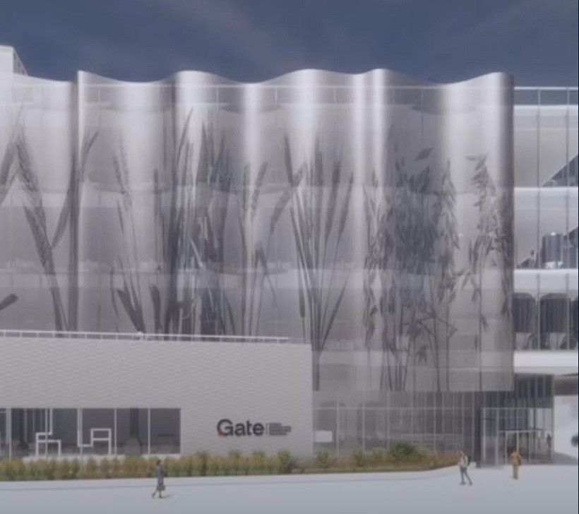 artists conception of facility, large white building with waves of wheat painted on the side housing the new GATE facility