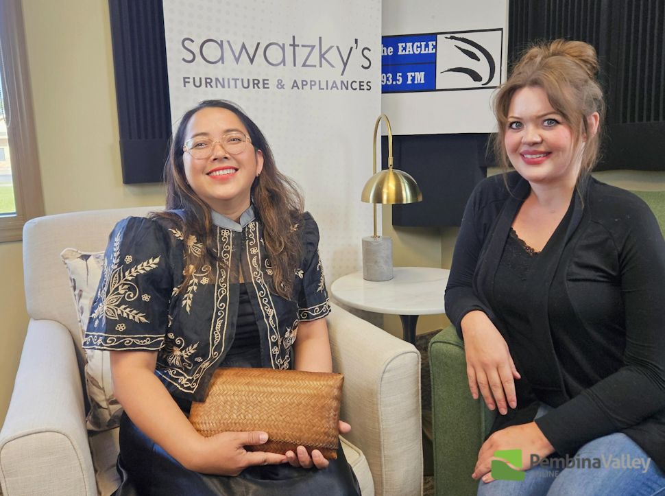 two women sit in a studio