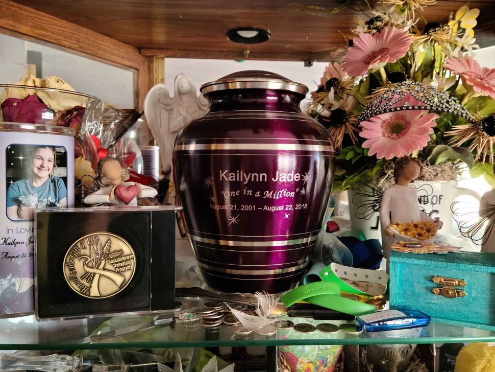 photo shows memorial table with Kailynn's photo, urn, and transplant medal for her gift of life