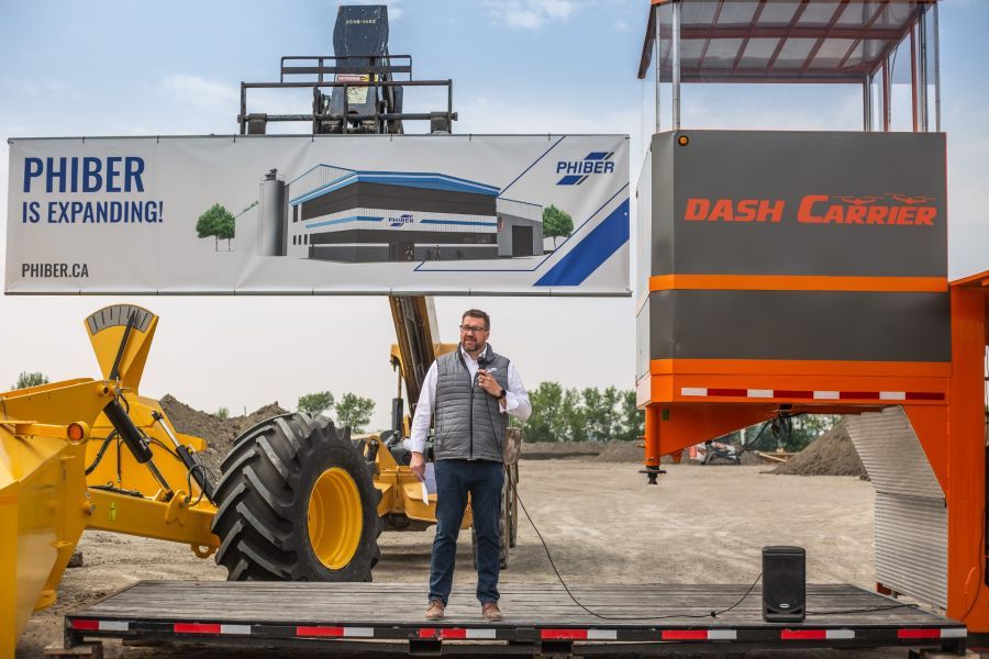 a man standing on a flat deck trailer