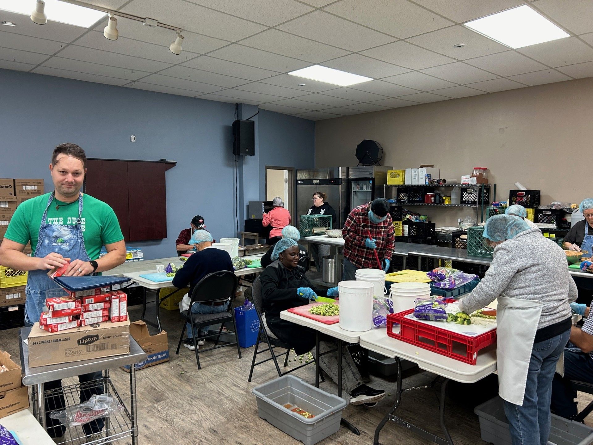 Volunteers work to prepare meals at Agape Table