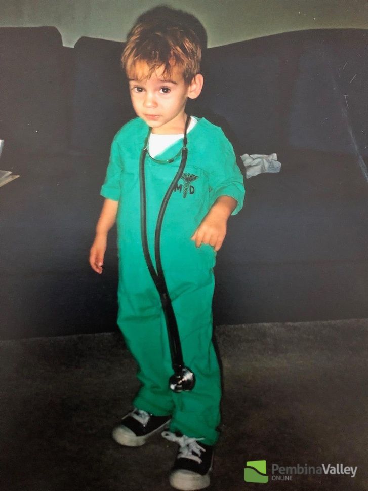 a young boy dressed as a doctor