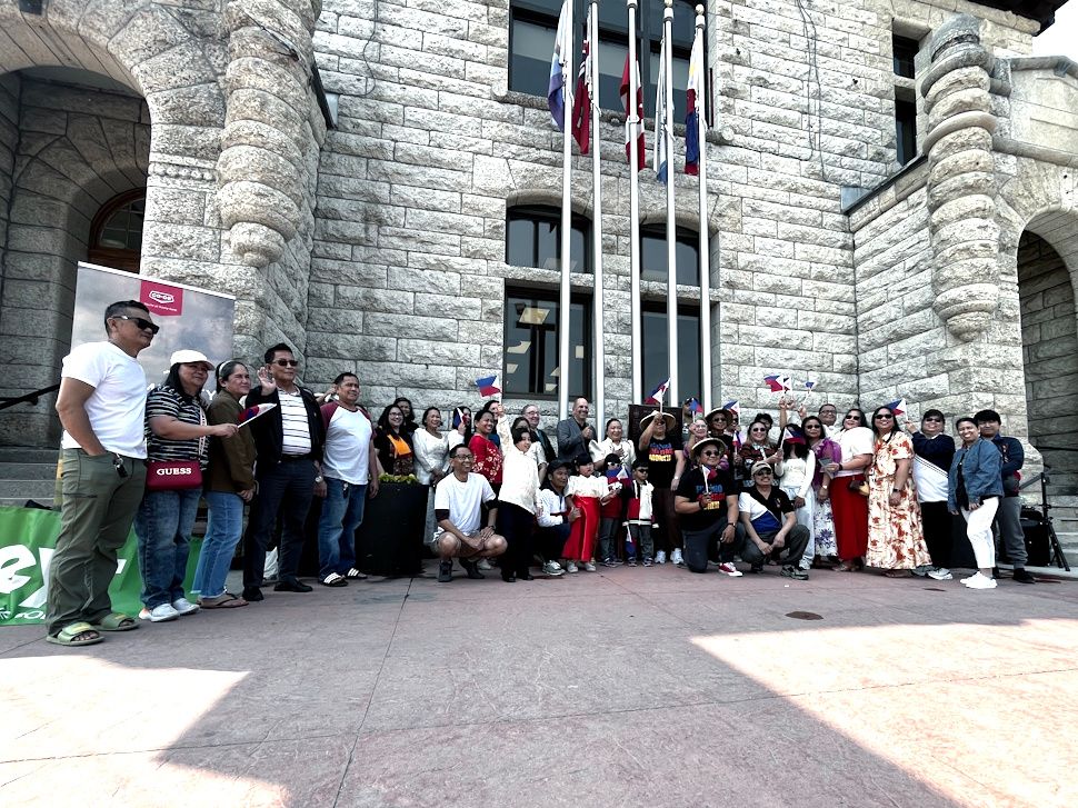 Group photo of Filipino community members, city officials, and attendees gathered on the front steps of Portage la Prairie City Hall for the Filipino Heritage Month flag-raising ceremony.