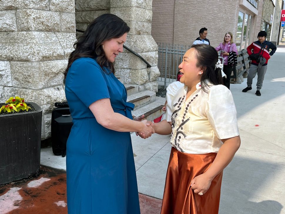 Mayor Sharilyn Knox greets a member of the Filipino community during the heritage flag-raising ceremony.